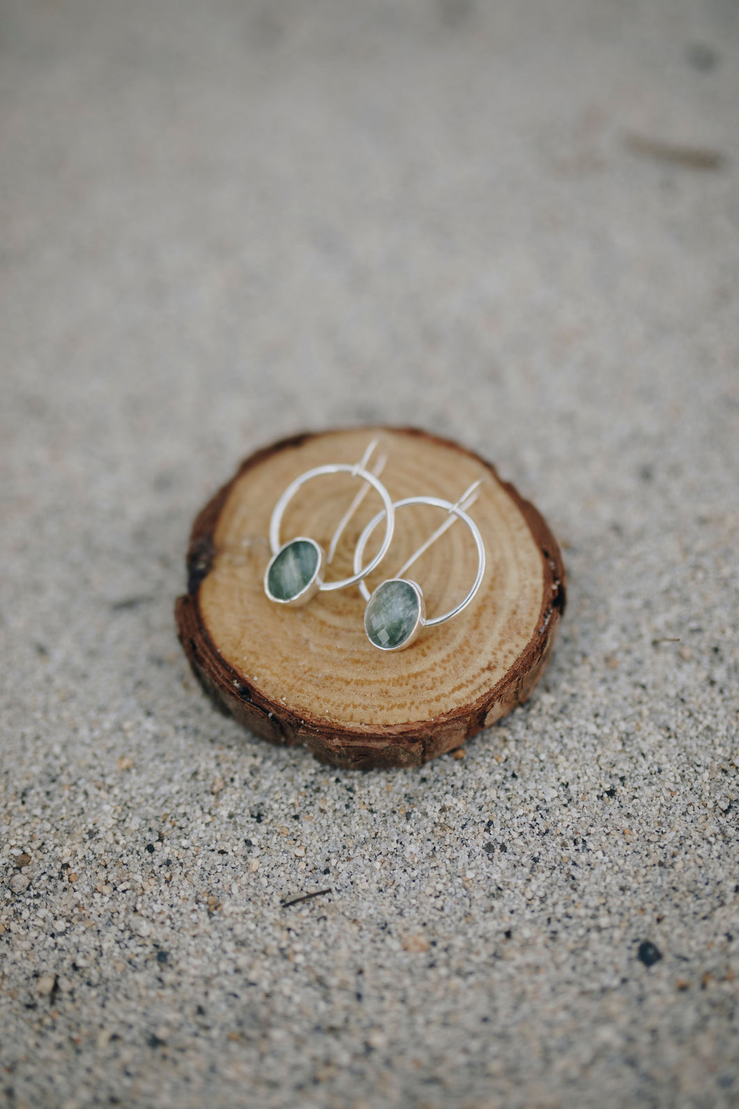 Serpentine stones set on sterling silver hoops. All handmade.                            